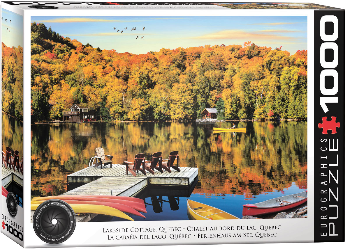 The artwork centers on a lakeside cottage in Quebec surrounded by fall color, capturing a seasonal change in the landscape.